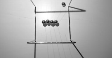What Actually Happens If You Shoot a Ball at a Newton’s Cradle?